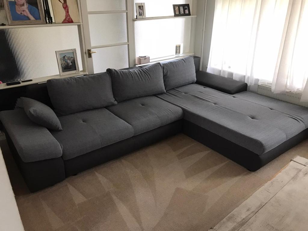 This is a photo of a grey L shape sofa that has been professionally steam cleaned, also the beige carpets have been steam cleaned too works carried out by Haggerston Carpet Cleaning