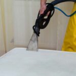 This is a photo of a man steam cleaning a dirty mattress Haggerston Carpet Cleaning